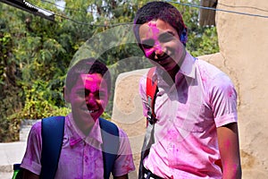 Two boys are playing in colors in happy posture, Concept for Indian festival Holi