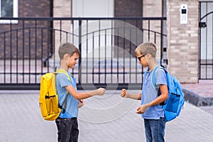 Two boys playing rock paper scissors game after school