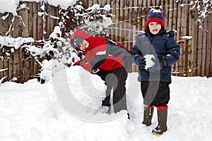 Two boys playing in the snow photo