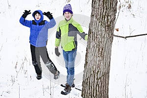 Boys Playing in the Snow in Forest photo