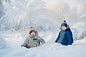 Two boys playing in a winter forest, the brothers