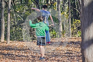 Two Boys Pointing at Something the See in Nature