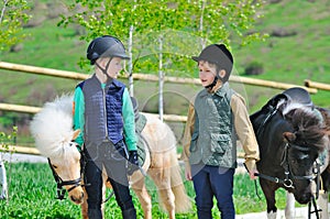 Two boys with ponies