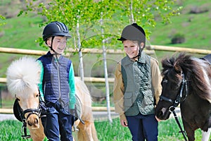 Two boys with ponies