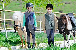 Two boys with ponies