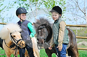 Two boys with ponies