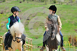 Two boys with ponies