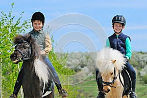 Two boys with ponies