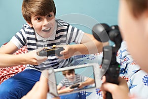 Two Boys Recording Gaming Blog In Bedroom