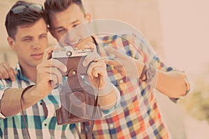 Two boys with retro photo camera