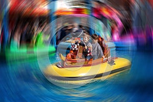 Two boys, riding boat in amusement park