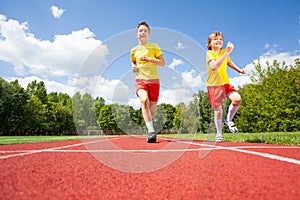 Two boys run while competing to each other