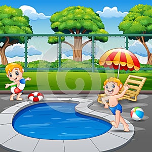 Two boys running on pool edge in backyard