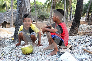 Two boys from Sawu island with coconut, Indonesia