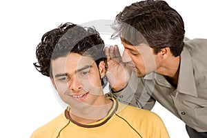 Two boys sharing funny secrets