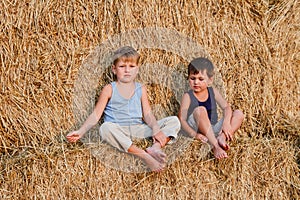 Two boys sit on the big barn