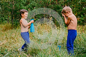 Two boys splashing water in summer