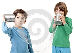 Two boys talking on a tin can phone