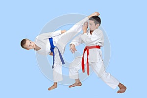 Two boys train a circular kick and block