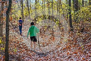 Two Boys Walking in Fall Forest