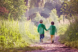 Two boys walking in park