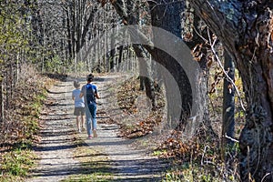 Two Boys Walking on a Path in Woods photo