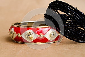 Two bracelets. Beaded bracelet and metal bracelet. Female bijutrei. A pair of jewelry. Red bracelet. Spring. Spring bloom.