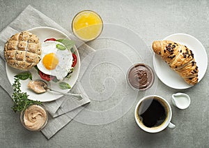 Two Breakfast with croissants and coffee and egg sandwich wiith juice