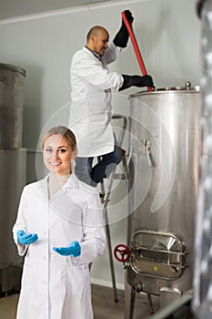 Two brewery workers on beer factory