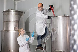 Two brewery workers on beer factory