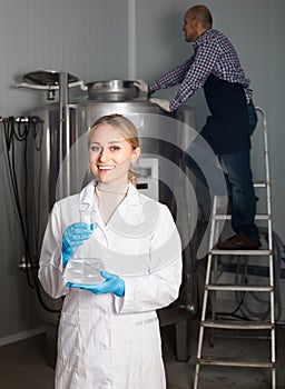 Two brewery workers on beer factory