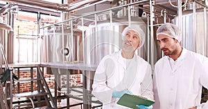 Two brewery workers working together