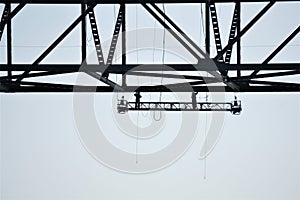 Two bridge workers silhouetted under deck slab