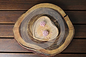 Two brigadiers of red fruits on a cracked wooden trunk board top view. photo