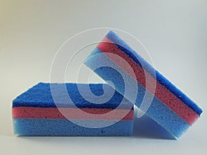 two bright blue sponge on white background photo