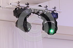 Two bright illuminators devices rays of green light photo