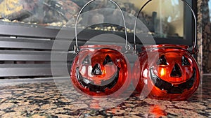 Two bright orange candlesticks in the form of pumpkins Jack-o-lantern Glass lantern with real candles Black eyes and