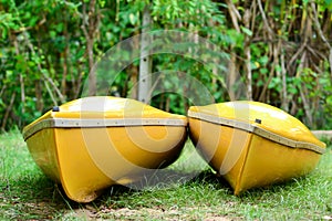 Two bright yellow kayaks sit side by side