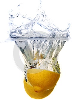 Two bright yellow lemons dropped in water