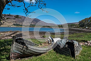 Two Broken boats near a lake