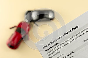 Two broken cars and car insurance document