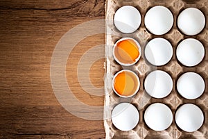 Two broken eggs in the egg box