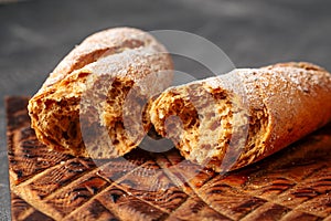 Two broken loafs of fresh baked baguette