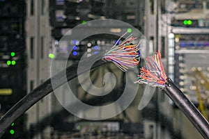 Two broken pieces of telecommunication wire. There is a damaged telephone Internet cable in the server room of the data center.