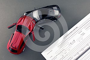 Two broken toy cars and car insurance