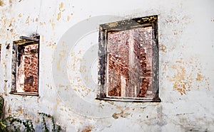 Two broken windows in an abandoned house