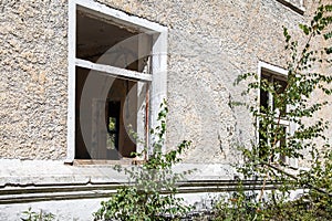 Two broken windows in an abandoned house