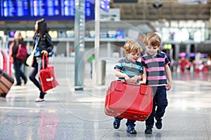 Two brother boys going on vacations trip at airport