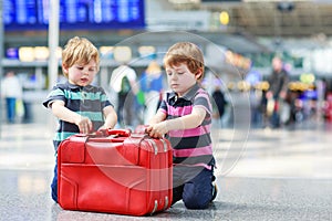 Two brother boys going on vacations trip at airport