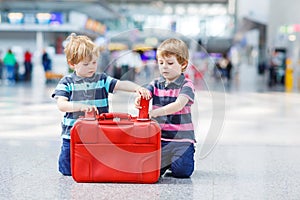 Two brother boys going on vacations trip at airport